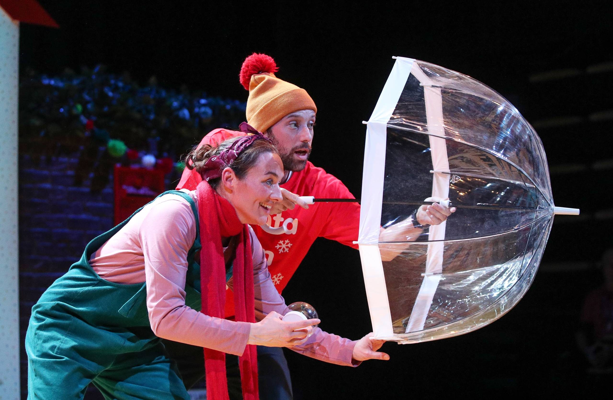 Male and female character hide behind an umbrella.