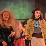 A young man and woman in costume performing on stage during our Summer Youth Project in 2018's Les Misérables Schools Edition.