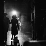 Silhouette of couple walking into the light on stage