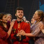 3 young females swooning over a young man performing in a navy uniform from our 2016 Summer Youth Project - The Pirates of Penzance.